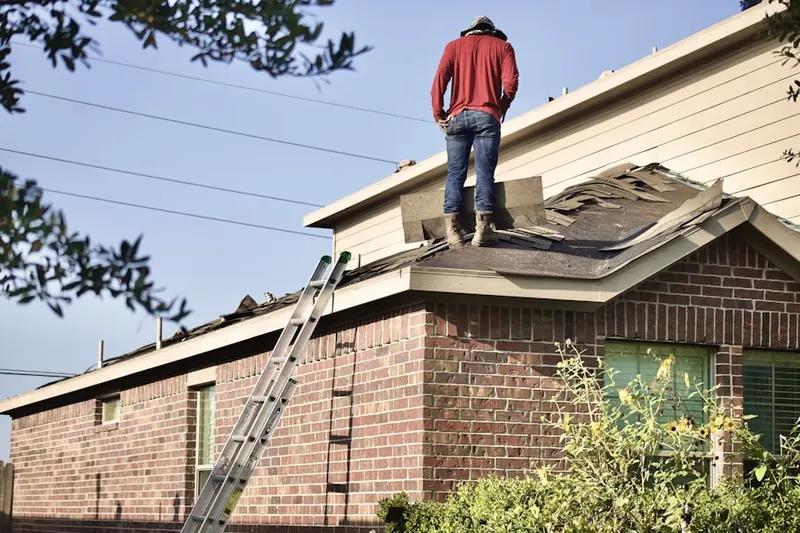 Professional roofer working on a residential roof in Palm Springs Panorama